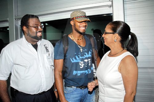 Contributed
LIME?s vice president, marketing, Wayne Lawrence (left) and Minister of State in the Office of the Prime Minister, Shahine Robinson (right) were among the delegation that greeted World 100M bronze medalist, Asafa Powell at the Norman Manley International Airport.  Asafa, World and Olympic 400M Silver Medalist, Shericka Williams and 100M hurdles World Champion, Brigette Foster-Hilton returned to the island on Saturday.