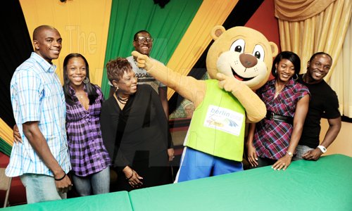 Ricardo Makyn/Staff Photographer.
Veronica Campbell-Brown posses with husband Omar Brown, minister of culture and sports Olivia Grange,  World Championships mascot Berlino, and other members of the Jamaican team who arrived at the Norman Manley International Airport yesterday.