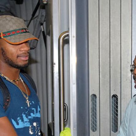 ic 1
State Minister in the Office of the Prime Minister (OPM), the Hon. Shahine Robinson (right) greets world 100 metres bronze medalist, Asafa Powell (left) shortly after his arrival at the Norman Manley International Airport,Kingston, Saturday night (September 26). Next to the Minister is Dr Warren Blake, 2nd Vice President of the Jamaica Amateur Athletics Association (JAAA).