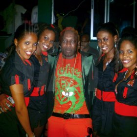 Elephant Man strikes a pose with the 'Ladies of Musique'
