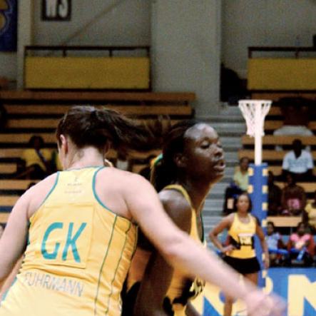 Winston Sill / Freelance Photographer
Jamaica's goal shooter Romelda Aiken (centre) tussles for position against Australia goal keeper Susan Fuhrmann during their NCB Sunshine Series match at the National Indoor Sports Centre on Saturday. The series ended 1 - 1.