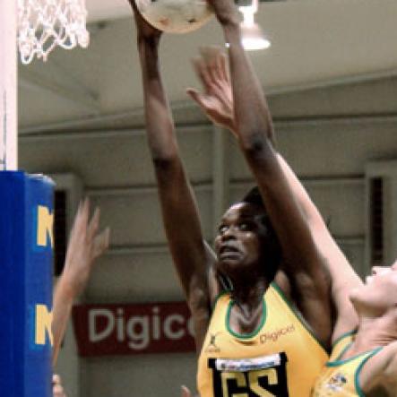 Winston Sill / Freelance Photographer
Jamaican goal shooter Romelda Aiken (left) out-jumps Australia goal keeper Susan Fuhrmann for possession during their NCB Sunshine Series match-up at the National Indoor Sports Centre on Saturday. The series ended tied at 1 - 1.