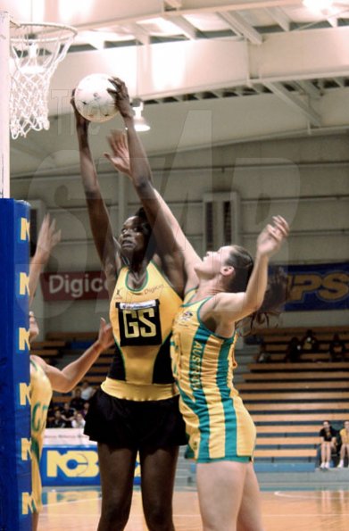 Winston Sill / Freelance Photographer
Jamaican goal shooter Romelda Aiken (left) out-jumps Australia goal keeper Susan Fuhrmann for possession during their NCB Sunshine Series match-up at the National Indoor Sports Centre on Saturday. The series ended tied at 1 - 1.