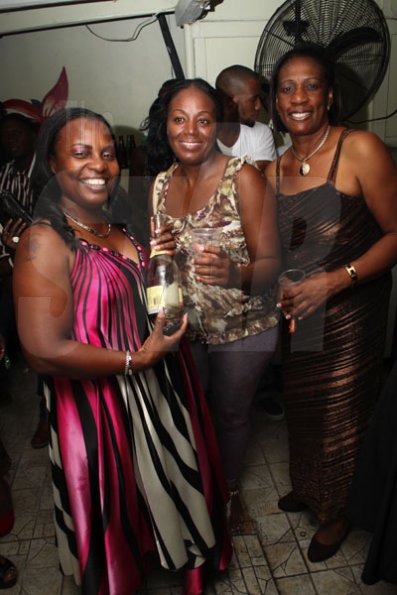 Anthony Minott/Freelance Photographer
These ladies strike a pose with wine bottle  and cups in hand during a Bailey's New Year's Eve party atop the roof of Ken's Wildflower, Bayside, Portmore.