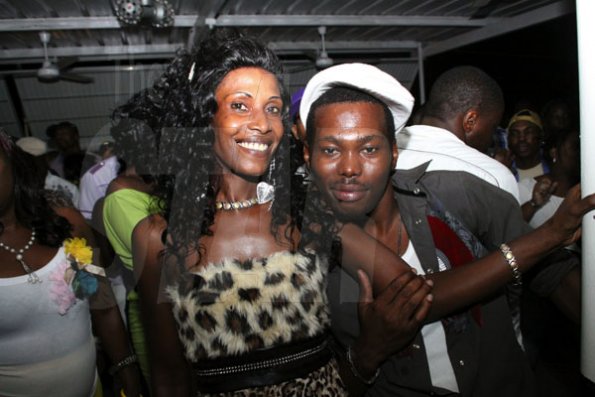Anthony Minott/Freelance Photographer
Disc jock and his date in a party mood during a Bailey's New Year's Eve party atop the roof of Ken's Wildflower, Bayside, Portmore.