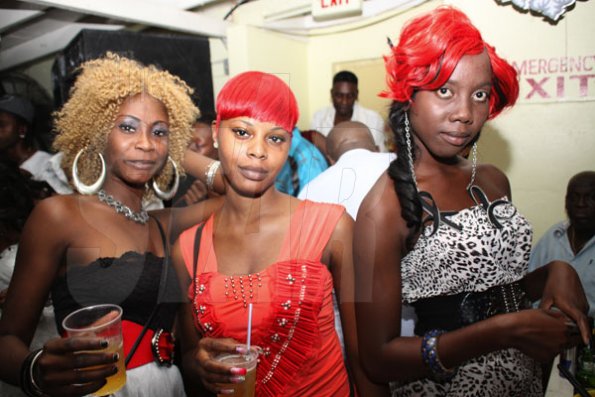 Anthony Minott/Freelance Photographer
These ladies went for colourful hairstyles as they seek the lime light during a Bailey's New Year's Eve party atop the roof of Ken's Wildflower, Bayside, Portmore.