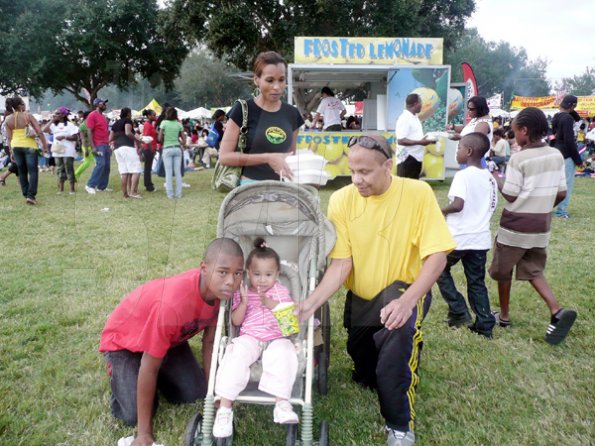 Keisha Shakespeare/Staff Reporter
Robert Taylor (left) brought his family, wife, Andrea, and children Jada (in stroller) and Joshua for a family's day out at the Grace Jamaican Jerk Festival USA.