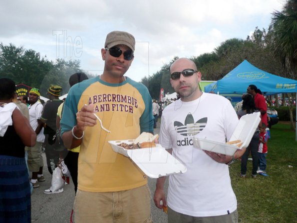 Keisha SHakespeare
COurtney Lake and his friend, Carlos Lopez who is having real Jamaican jerk for the first wolfing down some good ole Boston Jerk