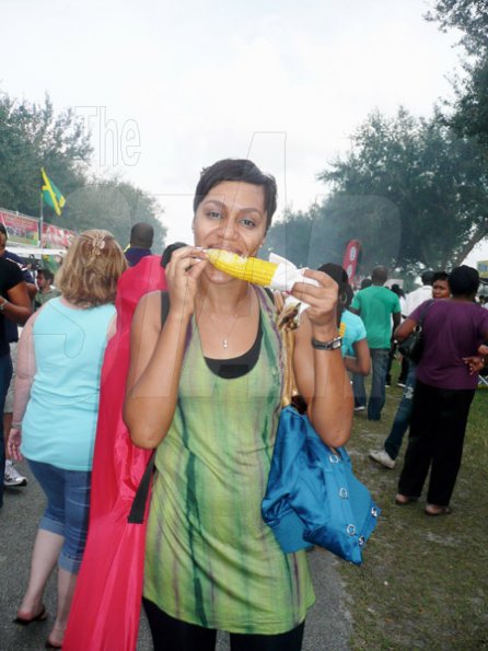 Keisha Shakespeare/Staff Reporter
Sheren Smith visiting the jerk festival for the first time and she is having a grand time while she enjoys a tasty boiled corn.