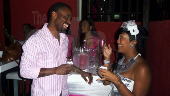 Photo by Hasani Walters 

Red Stripe Brand PR Manager LeVaughn Flynn (left) and Nuvo brand ambassador Tifa, engaged in conversation at Nuvo's Valentine celebration held at The House on Monday.