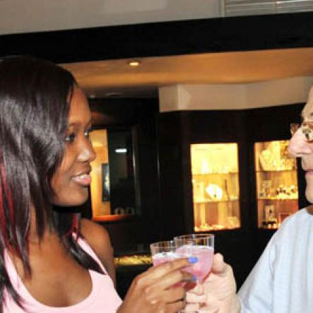 Contributed
Safia Cooper  of  Red Stripe toasts Swiss Stores Peter Bangerter with NUVO on Saturday February 12 during an in store promotion for Valentine's Day for the brand.