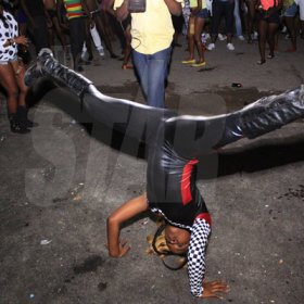 Anthony Minott/Freelance Photographer 
A Promotional girl for Turbo Energy drink dances on the head top during Pon Di Spot Fridayz held at Headley Avenue, Drewsland last Friday. The event is held every two weeks.