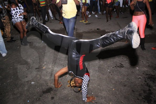 Anthony Minott/Freelance Photographer 
A Promotional girl for Turbo Energy drink dances on the head top during Pon Di Spot Fridayz held at Headley Avenue, Drewsland last Friday. The event is held every two weeks.