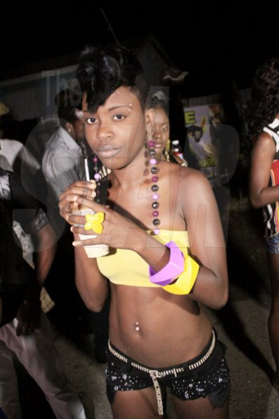 Anthony Minott/Freelance Photographer 
A female patron takes a drink during Pon Di Spot Fridayz held at Headley Avenue, Drewsland last Friday. The event is held every two weeks.