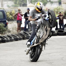 Anthony Minott/Freelance Photographer
Veteran Montego Bay biker, Ramond Gichie, performs a stunt.