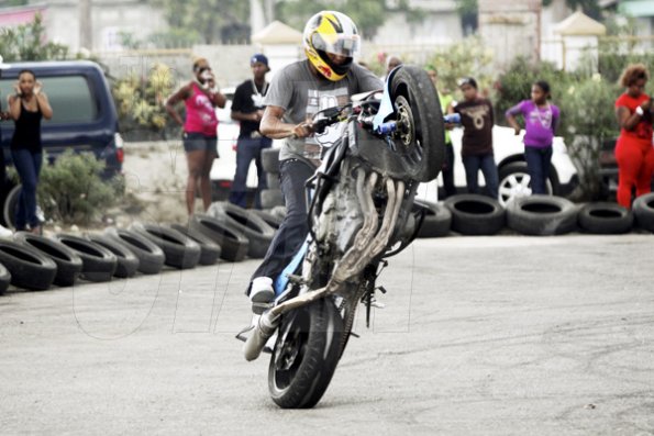 Anthony Minott/Freelance Photographer
Veteran Montego Bay biker, Ramond Gichie, performs a stunt.