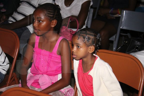 Anthony Minott/Freelance Photographer
Laciana (left), and Annaliese Brown glued to the action  during the Portmore Dancers Theatre Company Season of Dance 2010, at the Portmore HEART Academy on Saturday, June 12, 2010. The season lasted for two days, Saturday, June 12, and Sunday, June 13.
