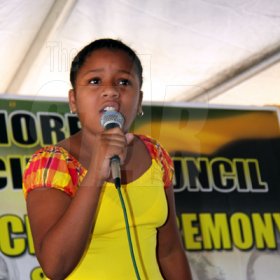 Anthony Minott/Freelance Photographer
Beianka Tomlinson, of PGA Preparatory recites a poem in tribute to national heroe Paul Bogle during a Portmore Municipal Council's Heroes Day ceremony at the Portmore Pines Plaza, Portmore, St Catherine, on Monday, October 19, 2009. A record 400-plus people attended the function.
