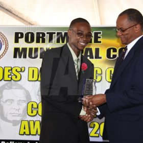 Anthony Minott/Freelance Photographer
Senator Arthur Williams (right), hands over an academic award to Andre Bascoe during  a Portmore Municipal Council's Heroes Day ceremony at the Portmore Pines Plaza, Portmore, St Catherine, on Monday, October 19, 2009. A record 400-plus people attended the function.