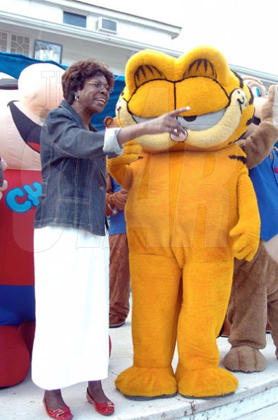 Peta-Gaye Clachar/Freelance Photographer
Mrs. Lorna Golding chills out with Garfield at the Prime Minister's Christmas treat for children at Vale Royal on Wednesday, December 9, 2009.