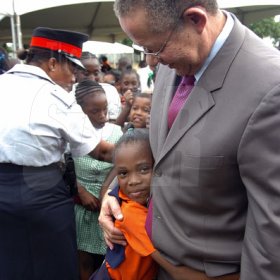 Peta-Gaye Clachar/Freelance Photographer
Nickiesha Allen from the Denham Town Primary is delighted to meet Prime Minister Bruce Golding at a Christmas treat he hosted for children at Vale Royal on Wednesday, December 9, 2009.
