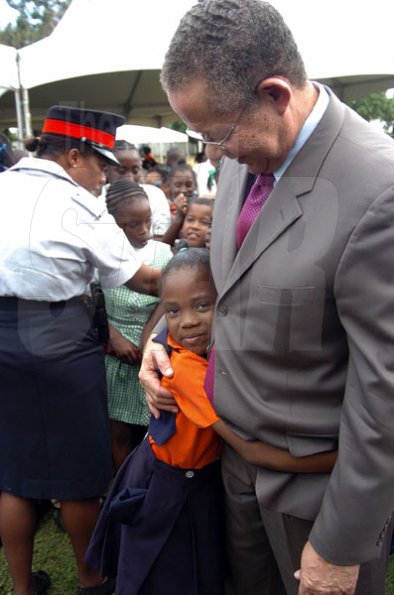 Peta-Gaye Clachar/Freelance Photographer
Nickiesha Allen from the Denham Town Primary is delighted to meet Prime Minister Bruce Golding at a Christmas treat he hosted for children at Vale Royal on Wednesday, December 9, 2009.