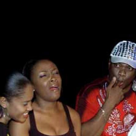 Winston Sill / Freelance Photographer
A look of horror creeeps unto this lady's face (centre) as Ragashanti irreverently dips his finger into his Birthday cake to have a taste during his Birthday Bash, at the Mas Camp, Oxford Road, New Kingston on Saturday night.








 September 11, 2010.