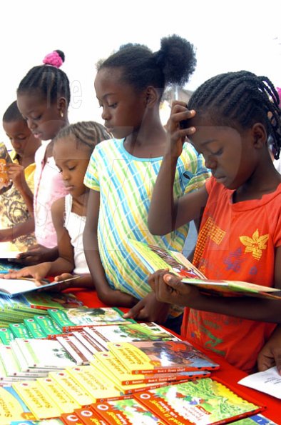 Peta-Gaye Clachar/Freelance Photographer
Students and children from all over browse through some books while at the Jamaica Library Service National Reading Fair at the Kingston and St. Andrew Parish Library on Saturday, November 28, 2009.From left to right is Tijean Walker, Toni-Ann Reid, Sydney Gayle and Tamika Stewart..