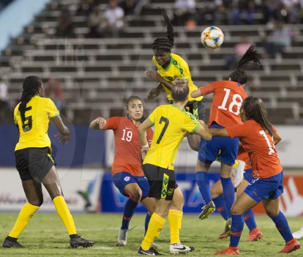 Jamaica's Khadija Shaw goes airborne to head the ball from a corner kick in international Women's friendly agains Chile at the national stadium on Thursday February 28, 2019.