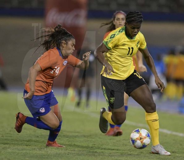 Jamaica's Khadija Shaw (right) on the offensive, tackled by Chile's Daniela Pardo in the International Womens friendly between Jamaica and Chile held at the National stadium on Thursday February 28, 2019