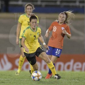 Jamaica's Chinyelu Asher (center) dribbles with he ball in the international womens friendly against Chile at the National stadium on Thursday February 28, 2019.