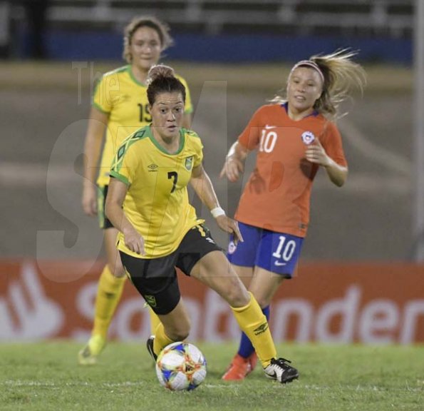 Jamaica's Chinyelu Asher (center) dribbles with he ball in the international womens friendly against Chile at the National stadium on Thursday February 28, 2019.