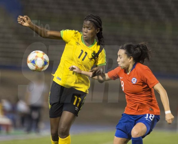 Gladstone Taylor/Multimedia Photo EditorJamaicas Khadija Shaw in a tussle with Chile's Camila Sáez (right) for possession of the ballin the Womens international friendly held at the national stadium on Thursday February 28, 2019.Reggae Girlz