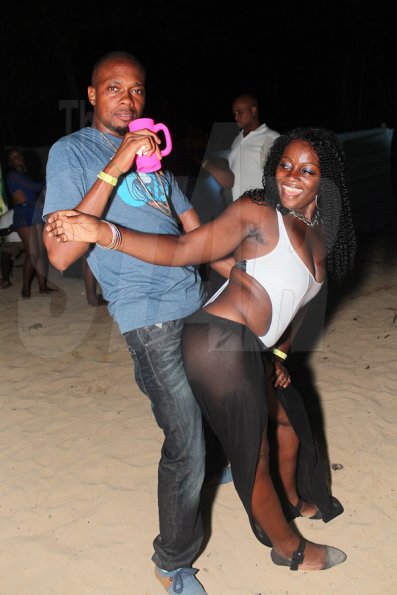 Anthony Minott/Freelance Photographer
A woman reacts as her male friend 'attacks' her from behind during Unleashed Entertainment's 'Reggae Luau' Beach Party held at Pearly Beach, Ocho  Rios, St Ann last Sunday.