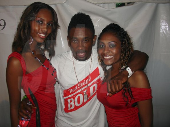 Contributed
Sumfest - Entertainer Chris Martin gets his bold on with Red Stripe Bold girls Shaneke Williams and Santina Taylor during International Night 1, Friday July 22 at Reggae Sumfest in Montego Bay.