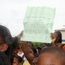Anthony Minott/Freelance Photographer
A female fan of Brown Sugar (partly hidden) hoist a placard in support of her favourite artiste during the KFC-sponsored Digicel Rising Stars road show at the Portmore Mall, on Saturday.