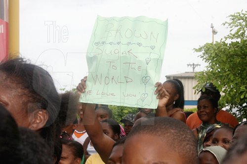 Anthony Minott/Freelance Photographer
A female fan of Brown Sugar (partly hidden) hoist a placard in support of her favourite artiste during the KFC-sponsored Digicel Rising Stars road show at the Portmore Mall, on Saturday.