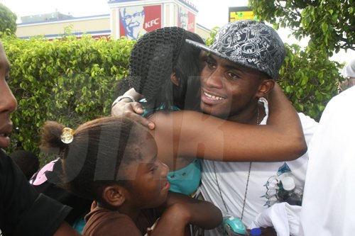 Anthony Minott/Freelance Photographer
Andrew Bonner (right) from the duo Moments gets a hug from a faan after a KFC-sponsored Digicel Rising Stars road show, featuring the top three contestants and departing fourth place winner, Moments at the Portmore Mall, on Saturday, August 29, 2009.