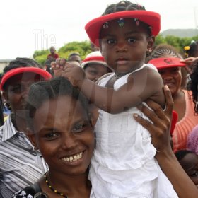Anthony Minott/Freelance Photographer
A baby gets a front stage view of the action during the KFC-sponsored Digicel Rising Stars road show, featuring the top three contestants and departing fourth place winner, Moments at the Portmore Mall, on Saturday, August 29, 2009.