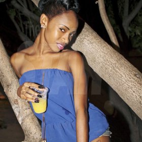 Anthony Minott/Freelance Photographer 
A female patron relaxes in a tree during Rumbar Chug it Sugarman's Beach, Hellshire in Portmore, St Catherine on Sunday, September 16, 2012.