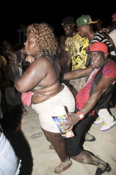 Anthony Minott/Freelance Photographer
CHEEKY: This man sneak up behind a female patron during Rumbar Chug it at Sugarman's Beach, Heroes Sunday, October 14, 2012