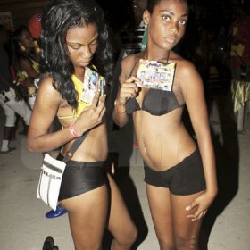 Anthony Minott/Freelance Photographer
These girls promote a party during Rumbar Chug it at Sugarman's Beach, Heroes Sunday, October 14, 2012