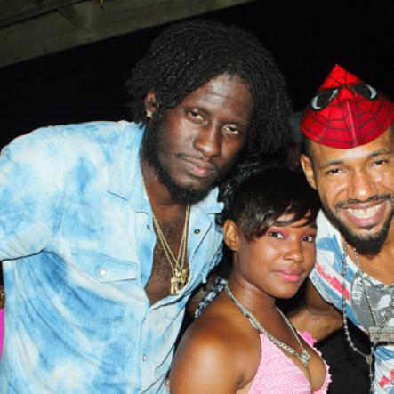 Anthony Minott/Freelance Photographer
Dancehall artiste Aidonia (left) hangs out with a female fan and artiste, King Cammar (right) before Aidonia performed on stage during Rumbar Chug it at Sugarman's Beach, in Hellshire last Sunday.