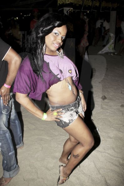 Anthony Minott/Freelance Photographer
She shows off her signature pose during Chug it...the Soca Edition at Sugar Man's Beach, Hellshire, Portmore, St Catherine on Sunday, March 18, 2012. Over 8,000 patrons, mainly youngsters attended the party.