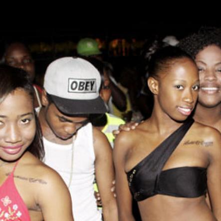 Anthony Minott/Freelance Photographer
A party crew pose for the camera during Chug it...the Soca Edition at Sugar Man's Beach, Hellshire, Portmore, St Catherine on Sunday, March 18, 2012. Over 8,000 patrons, mainly youngsters attended the party.