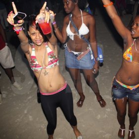 Anthony Minott/Freelance Photographer
These girls had arms raised as a Disc Jock played a popular tune during RumBar Chug it held at Sugarman's Beach, Hellshire, Portmore, St Catherine on Sunday, April 8, 2012. Despite a heavy downpour in the evening hours over 8,000 patrons still made the trek to the award-winning party series.