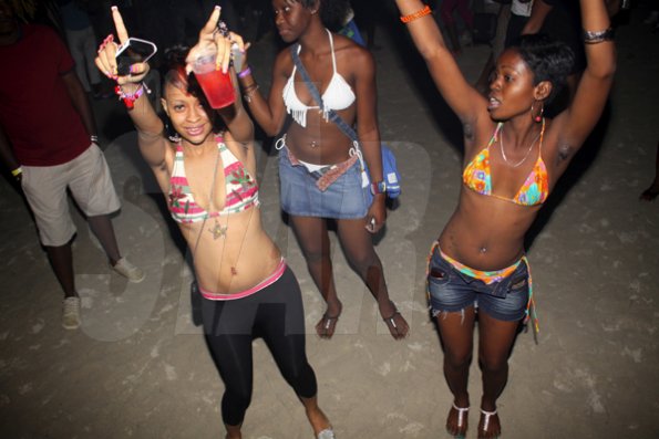 Anthony Minott/Freelance Photographer
These girls had arms raised as a Disc Jock played a popular tune during RumBar Chug it held at Sugarman's Beach, Hellshire, Portmore, St Catherine on Sunday, April 8, 2012. Despite a heavy downpour in the evening hours over 8,000 patrons still made the trek to the award-winning party series.