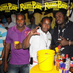 Anthoony Minott/Freelance Photographer
Container Boss, Ian Miles (centre), pose with dancehall artiste, Jah Vinci (right), and a member of the Container crew during RumBar Container Summer Party Series at Container Satdazs headquarters, Regent Street, Denham Town, in West Kingston on Saturday, July 14, 2012.