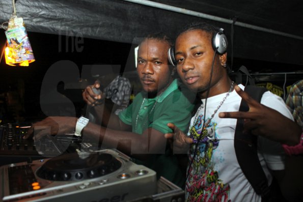 Anthoony Minott/Freelance Photographer
 DJ Damion (right), and DJ Barge had the crowd dancing with their musical selections during RumBar Container Summer Party Series at Container Satdazs headquarters, Regent Street, Denham Town, in West Kingston on Saturday, July 14, 2012.