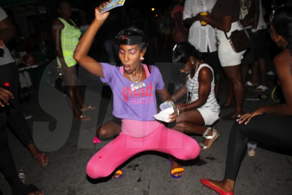 Anthoony Minott/Freelance Photographer 
Girls get down low as a hit song blares from the sound system Container Satdazs headquarters, Regent Street, Denham Town, in West Kingston on Saturday, July 14, 2012.